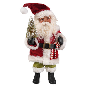 Red and white fuzzy vintage poseable kris kringle figurine by bethany lowe designs holding a snow-dusted tree