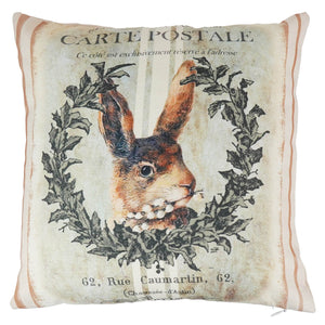 Beige wreath pillow with vintage rabbit illustration framed by holly leaves and french postal text spreading holiday cheer