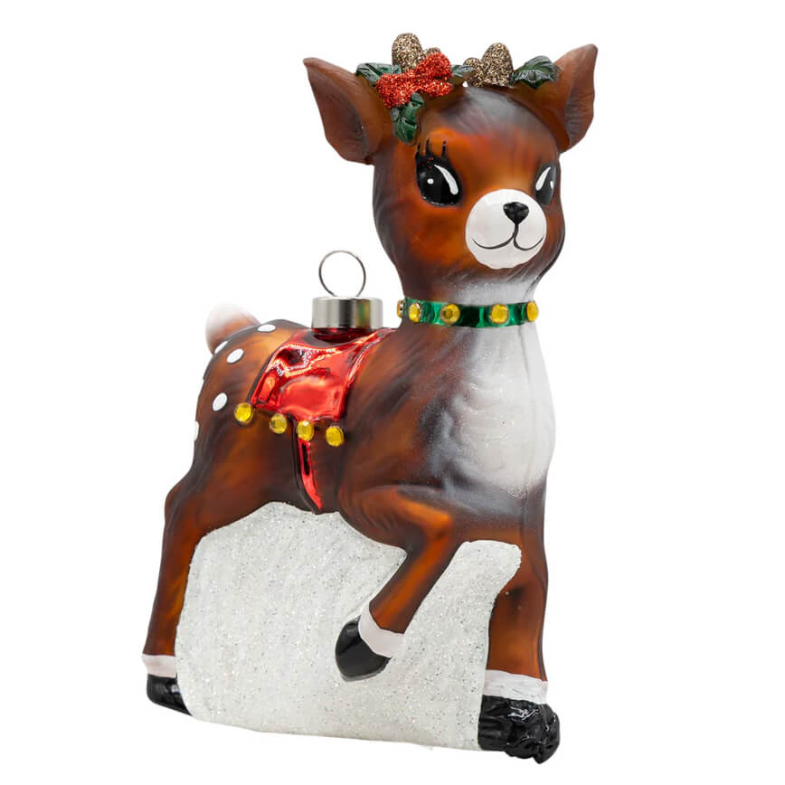 A vintage reindeer ornament featuring a brown and white glass reindeer with a red bow and green collar for classic christmas decor