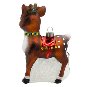 A vintage reindeer ornament with brown and white fur, green collar, red saddle, and glittery holly antlers for classic christmas decor
