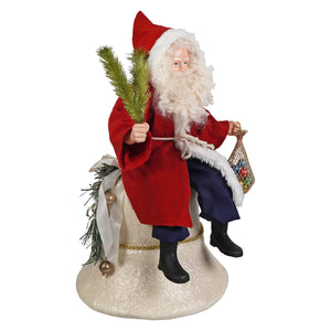 Vintage santa on bell figurine in red and white holding pine branches and colorful ornaments on a glittery base