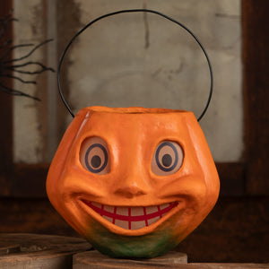 Vintage silly pumpkin bucket halloween bucket in bright orange with black wire handle and painted smiling face