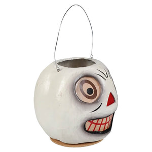 White ceramic vintage skeleton bucket shaped like a skull with red nose, teeth, and metal wire handle for halloween candy