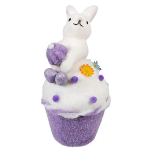 Purple and white cupcake-shaped bath bomb decorated with a bunny on top.