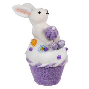 White bunny decorative cupcake ornament with purple accents and Easter eggs.