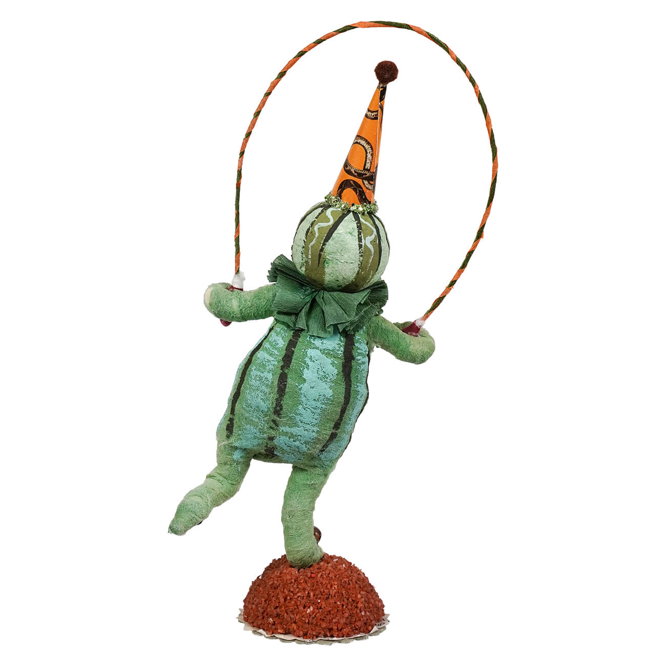 A handcrafted folk art scared pumpkin figure made of paper mache shaped like a green pumpkin holding a jump rope