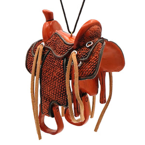 Red leather western braided saddle ornament with tan straps and black accents figural decor for western gear