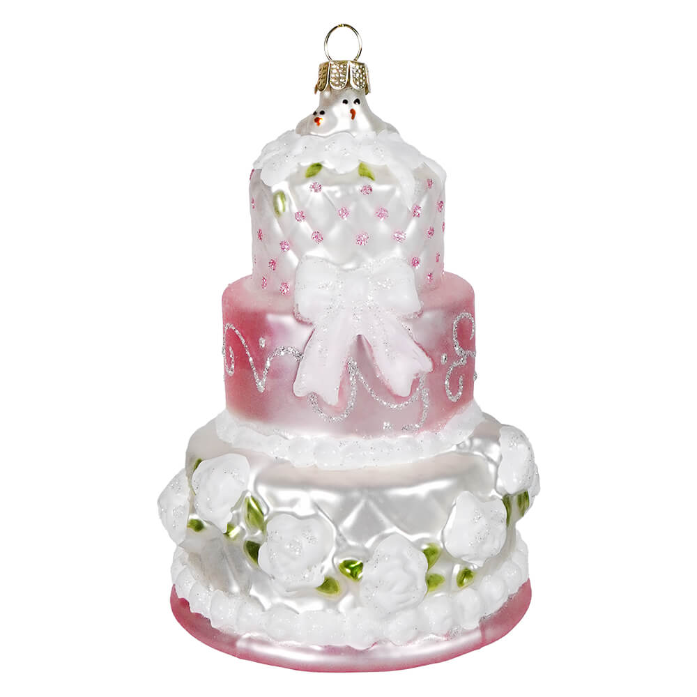 White bow wedding cake ornament with three tiers glass design pink and white frosting glittery food drink ornament