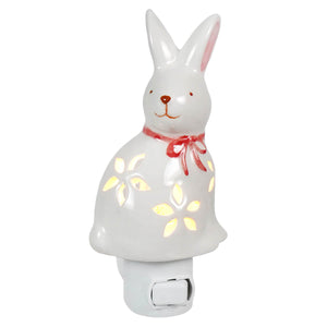 White ceramic easter bunny night light with pink ears red bow and glowing yellow floral cutouts perfect for holiday lights & lighted decor