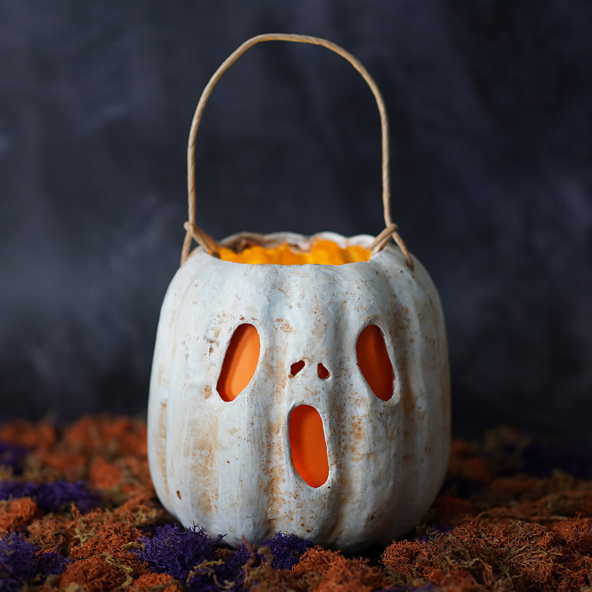 White ghost face pumpkin bucket with orange glowing interior handcrafted folk art ceramic lantern by raggedy junction design