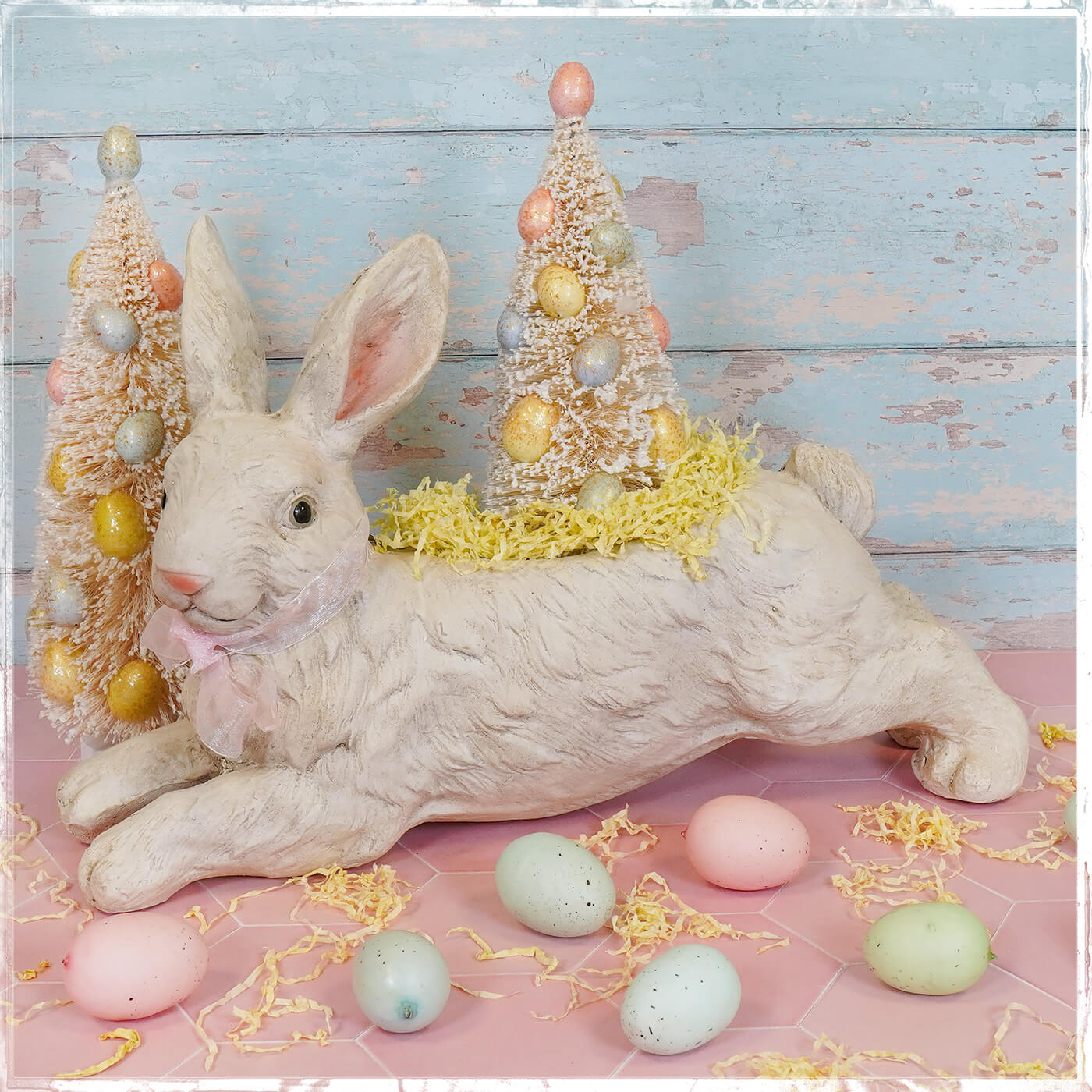 White leaping bunny planter made of textured resin with pink ears and bow vintage easter bunny figural decor