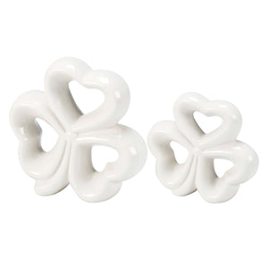 White ceramic decorative pieces shaped like interconnected hearts.