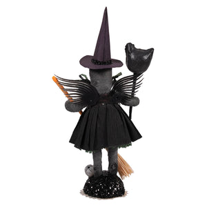 Black winged spun cotton witch figure with tall pointed hat and pleated skirt on glittery base for witch craft decor