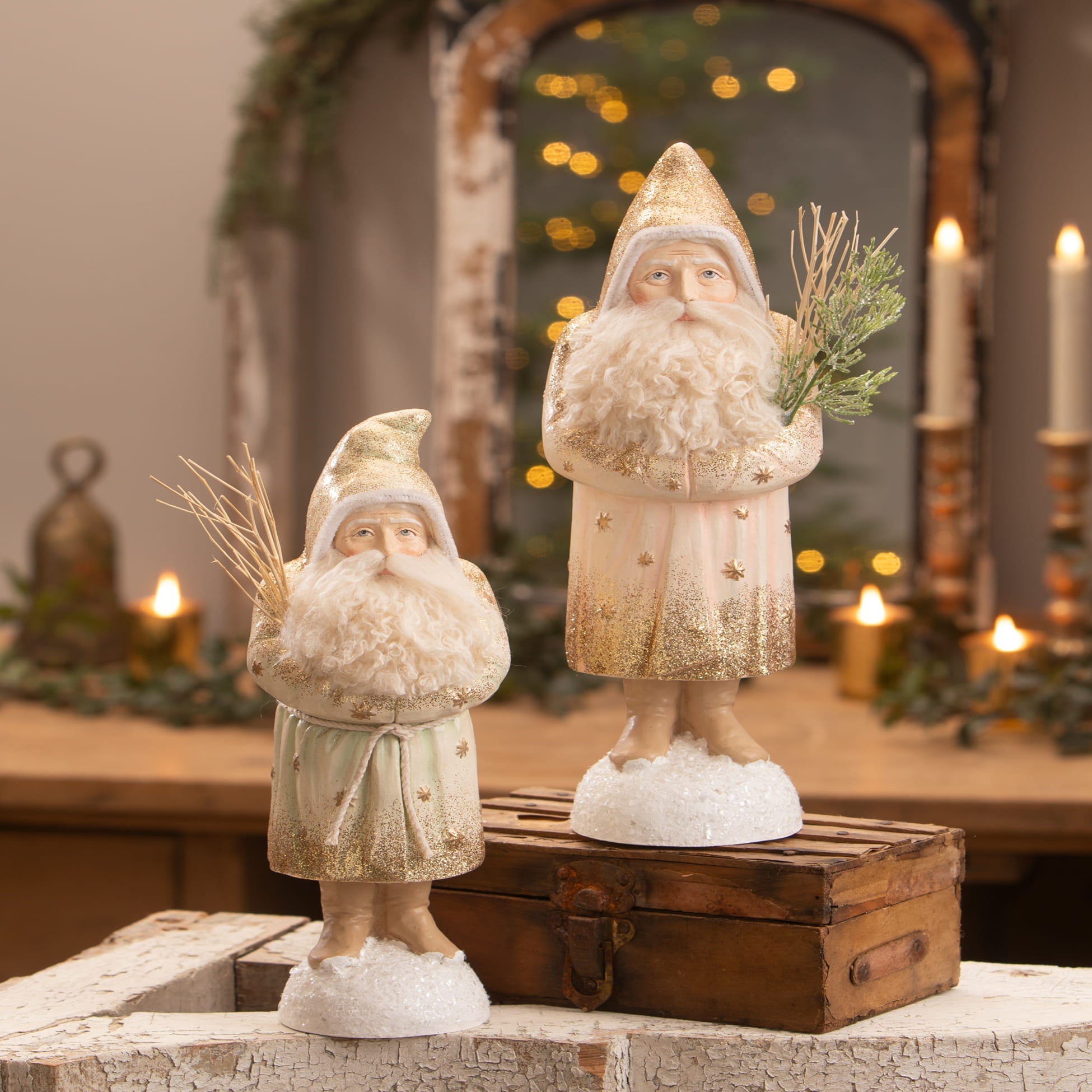 Two vintage-style winter blush belsnickle figurines with white beards gold glitter and snowy bases by bethany lowe designs