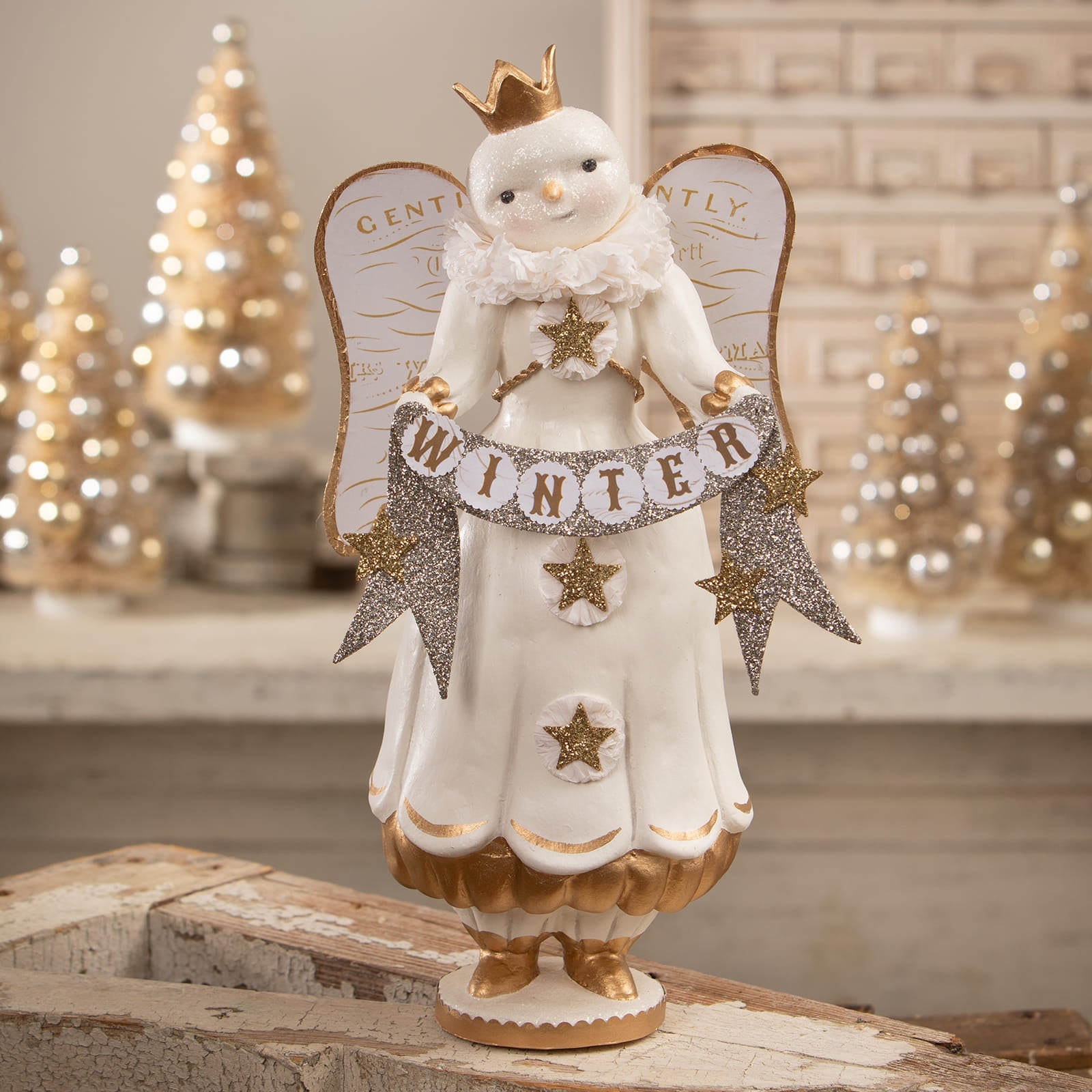 Large white porcelain snow angel figure with gold crown wings and trim holding a winter banner for angel figures decor