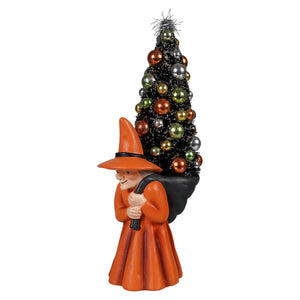 Orange witch figurine carrying decorated black christmas tree on her back halloween witches carrying tree decoration