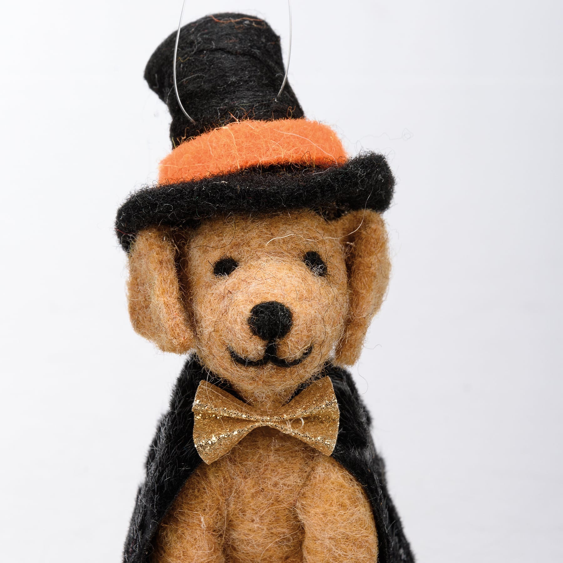 A charming tan felt witch dog critter ornament from kathy’s halloween collection wearing a black top hat and cape