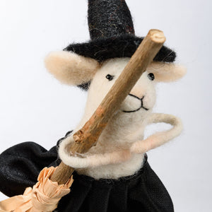 Whimsical white felt witch mouse critter wearing black wool hat and cloak holding broomstick from kathy’s halloween collection