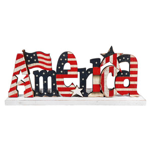 Decorative wooden ’America’ text sign painted with American flag stars and stripes pattern.