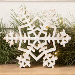 Rustic white wooden snowflake ornament with distressed finish and intricate geometric cutouts for holiday decor