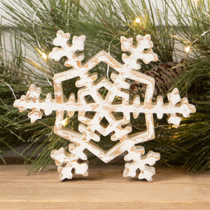 Rustic white wooden snowflake ornament with distressed finish and intricate cut out design for christmas decorations