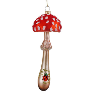 A woodlands toadstool mushroom ornament by cody foster in red and white glass with a ladybug on the stem