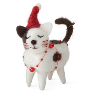 A charming white and brown wool holiday cat wearing a red santa hat and red bead necklace for christmas tabletop decor