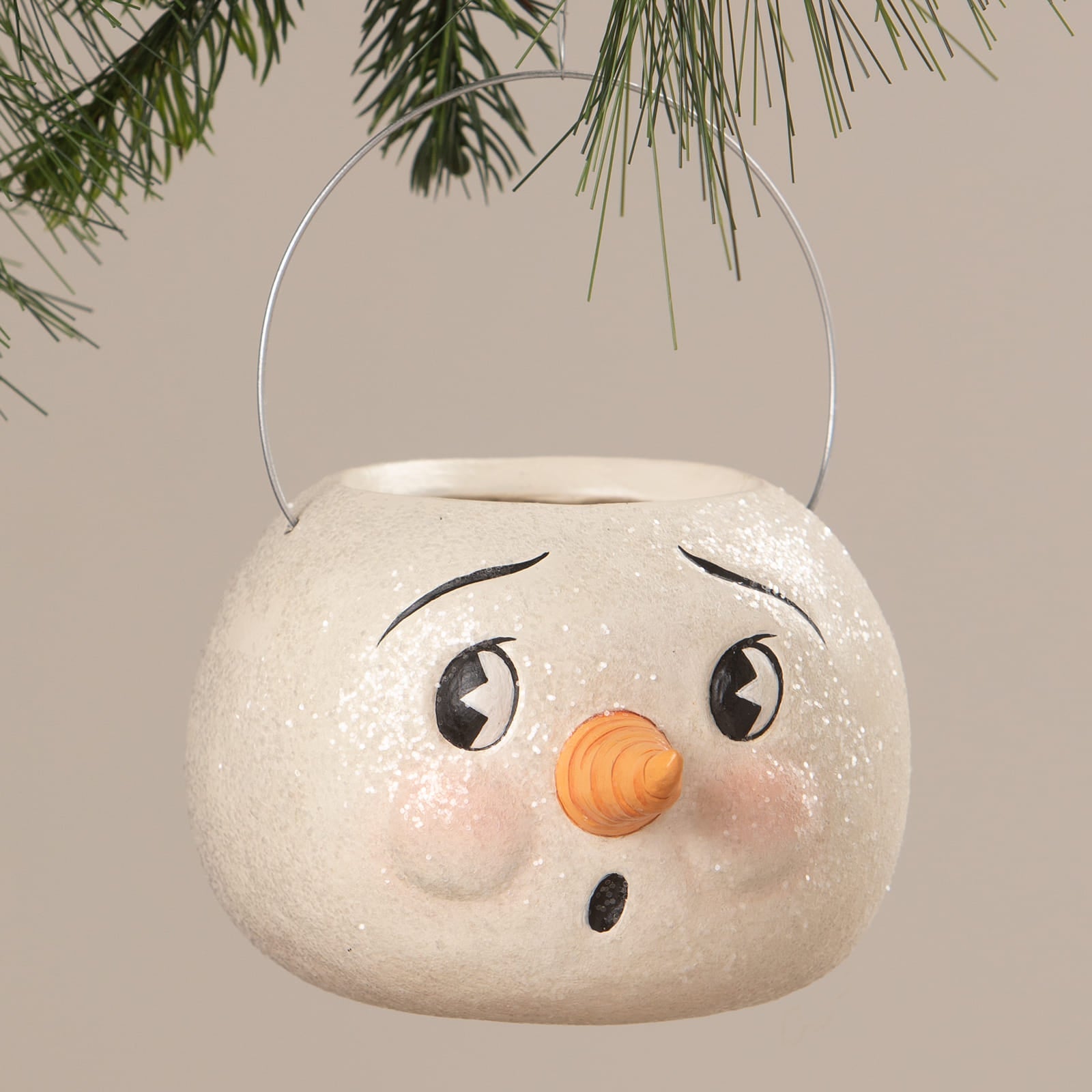 A white glittery snowman container with black eyes and carrot nose perfect as a jolly bobble snowman christmas bucket and lantern