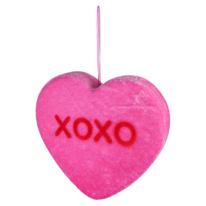 Pink heart-shaped decoration with ’XOXO’ written in red letters.