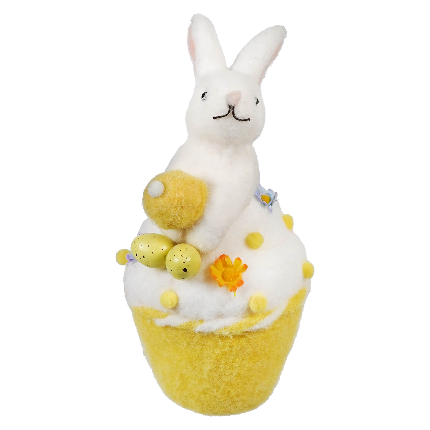 A white bunny sitting atop a yellow bath bomb decorated with flowers and bubbles.