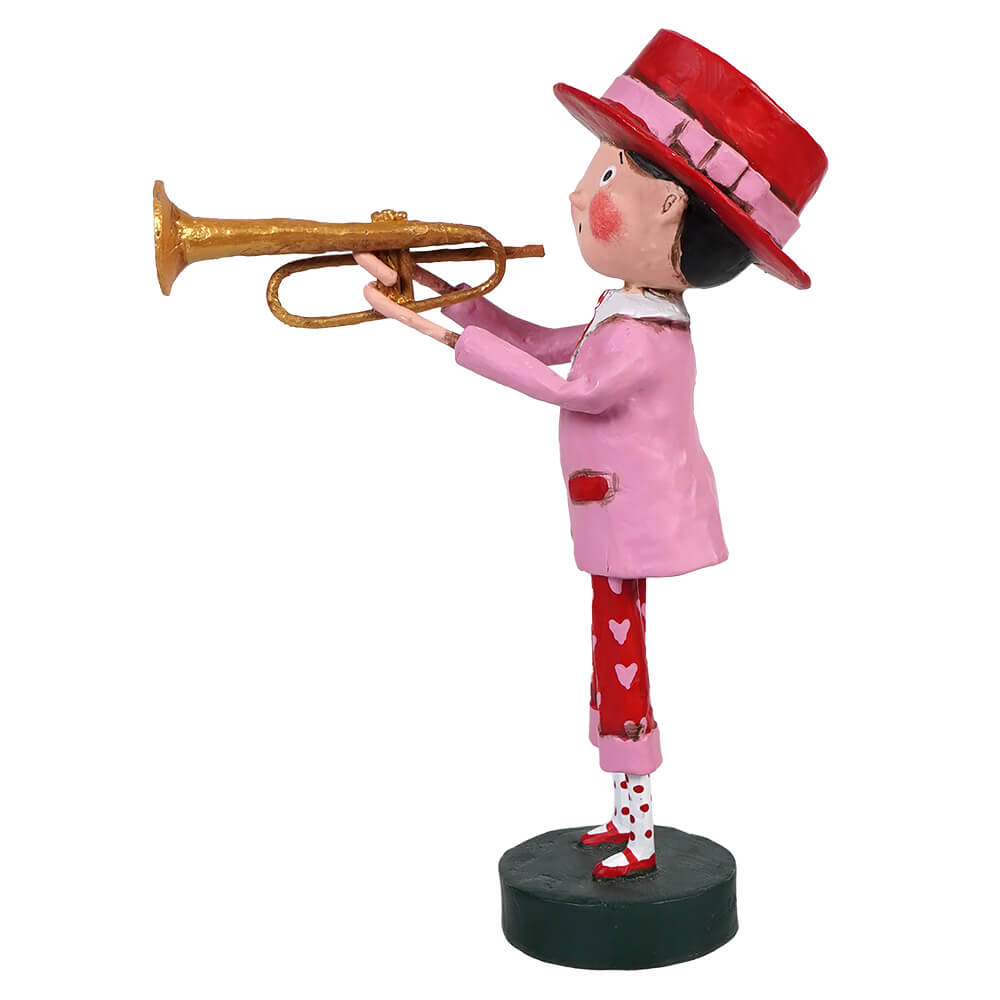 Decorative figurine of a trumpet player wearing a pink coat, red hat, and heart-patterned pants.